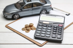 car and calculator on clipboard