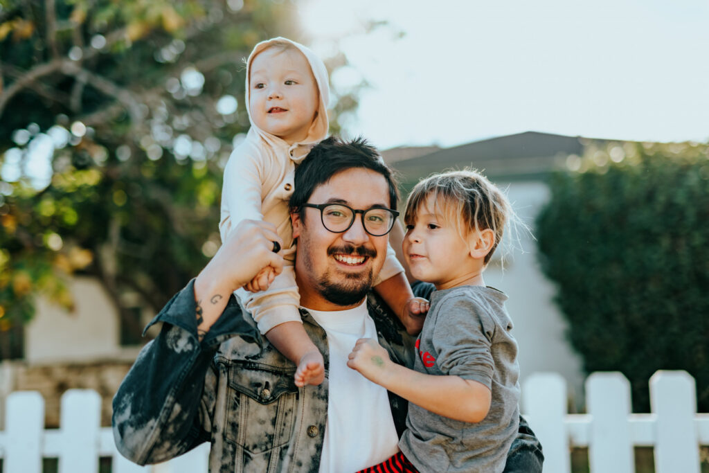 A father holding his two children
