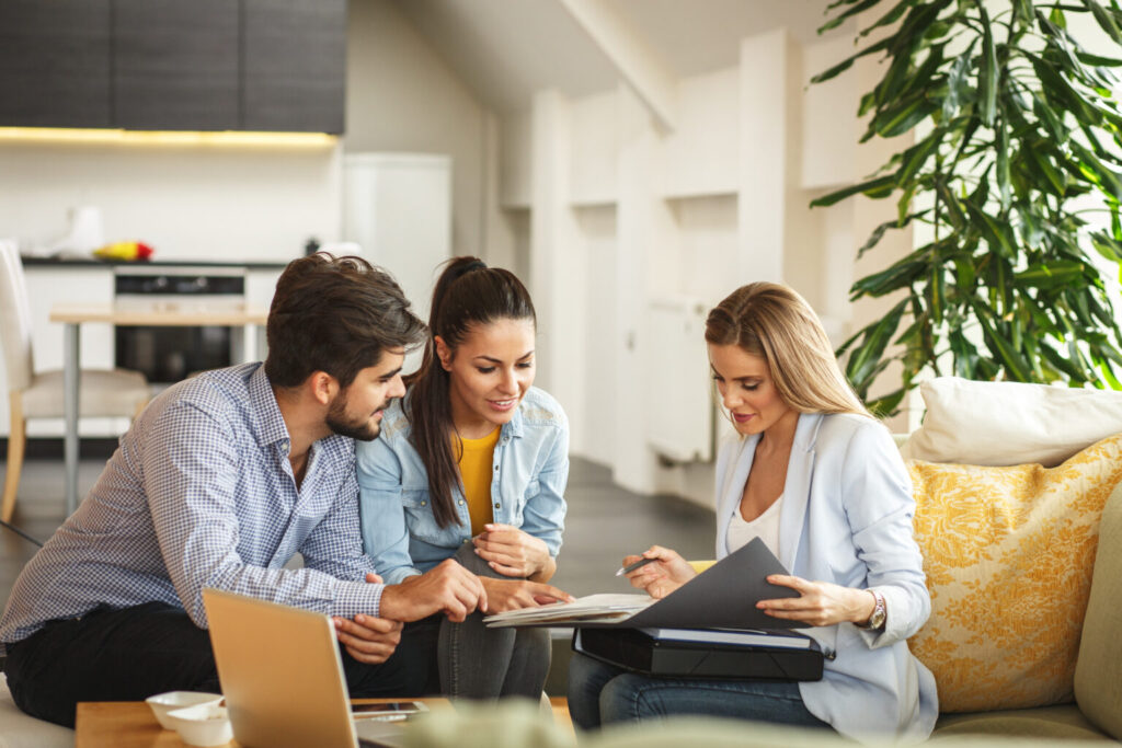 financial professional reviewing documents with a couple in their early thirties