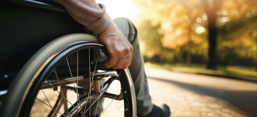 close up of an elderly man's hand as he sits in a wheelchair