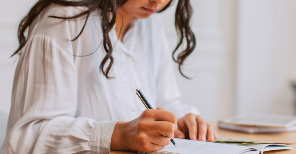 Young woman budgeting for her personal loan payment