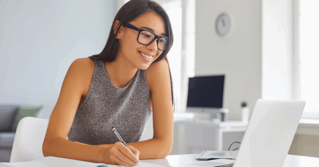 Woman smiling at her laptop