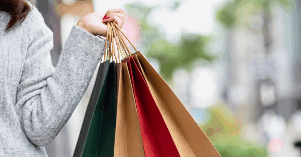 Woman carrying four shopping bags