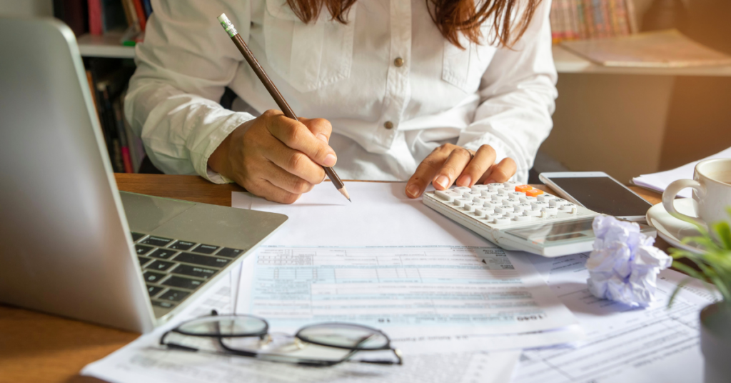 A woman in a white blouse filing her taxes